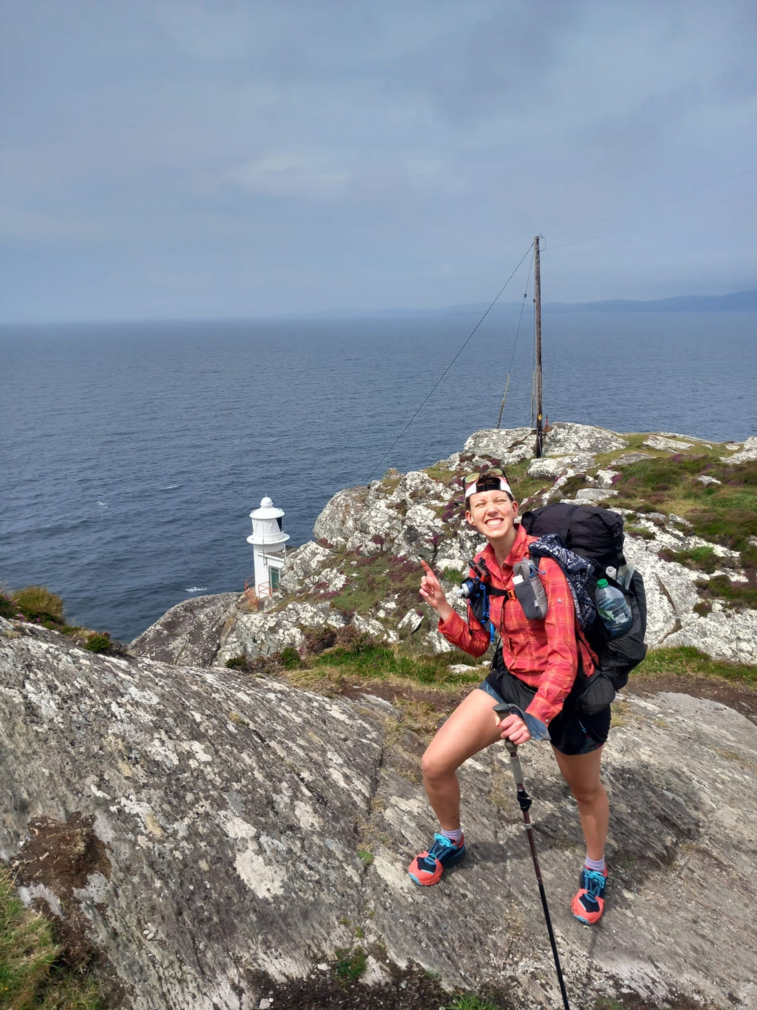 Leika on top of a cliff, looking down on the small lighthouse