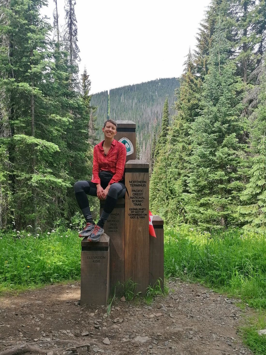 Me sitting on the Northern Terminus on the Canadian border